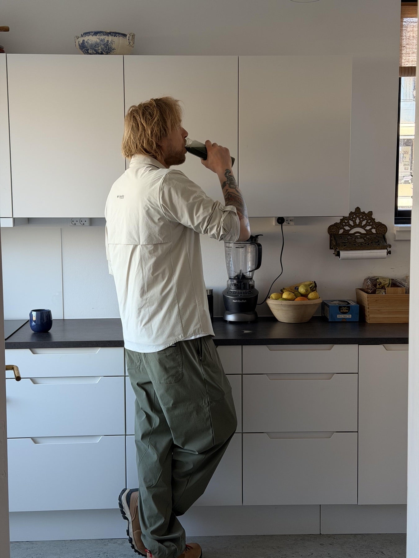 Felix Smith drinking aioss in kitchen